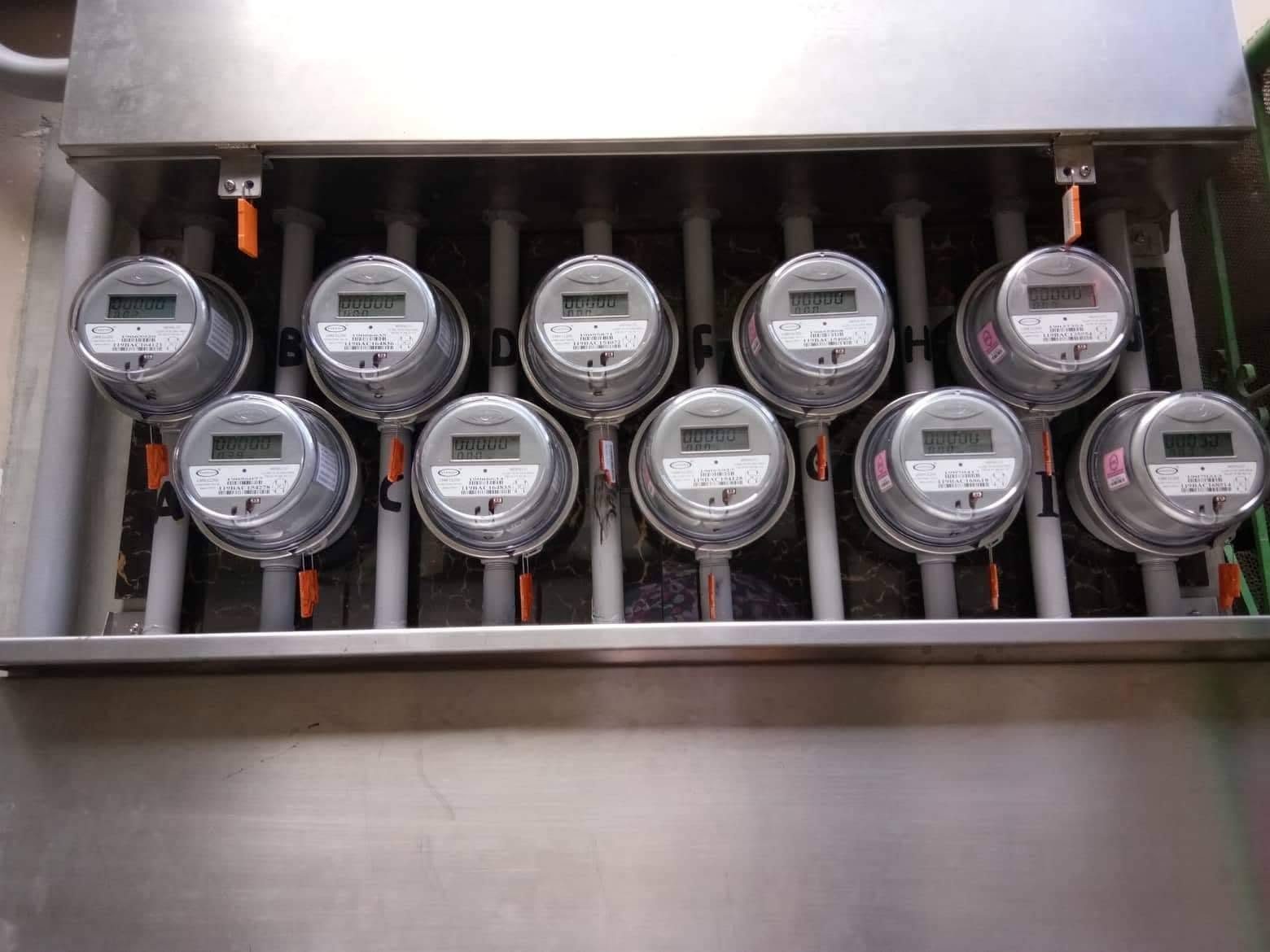 Finished ten-unit stainless steel electrical meter bank labeled A to J